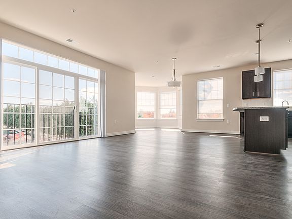 Living area with easy to clean hard surface flooring, tons of natural light