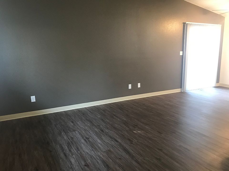 Living room to dining area with fresh accent wall and vinyl plank flooring