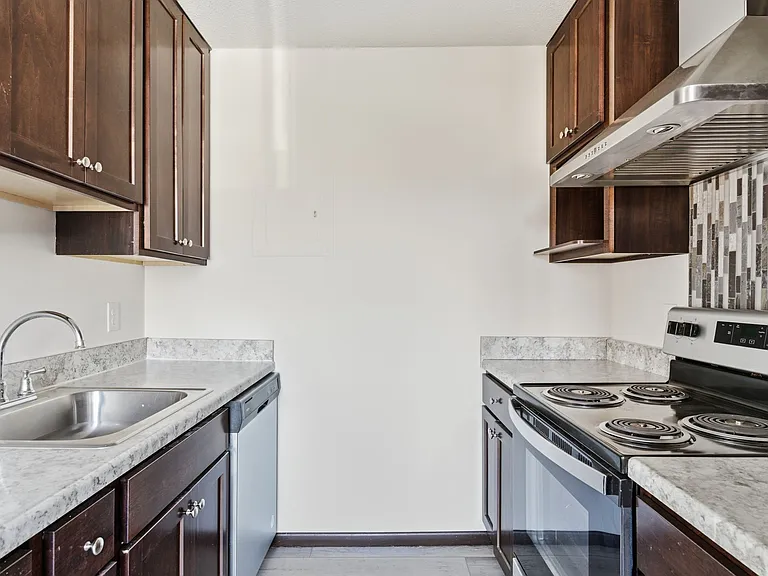 Elevate your living space at St. Anthony Group with our modern kitchen featuring sleek cabinetry, stainless steel appliances, and ample counter space. Perfect for culinary creations. Schedule your tour today and see the difference!