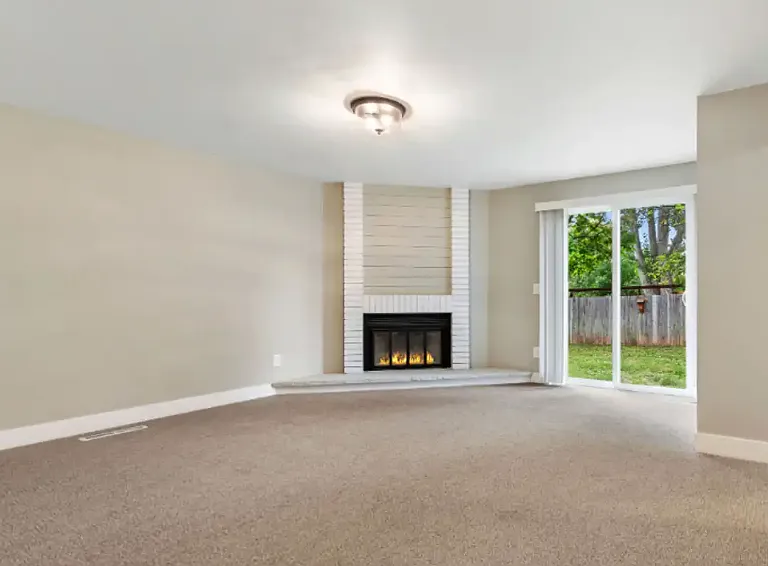Main floor primary bedroom with slider to fenced backyard.