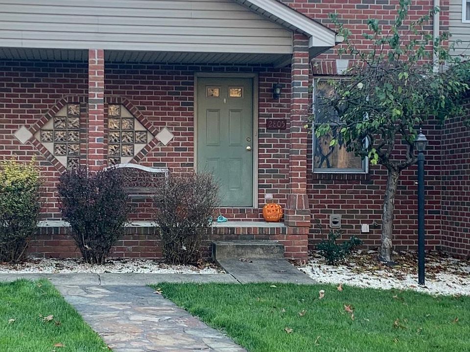 Flag stone sidewalk to covered porch and front door
