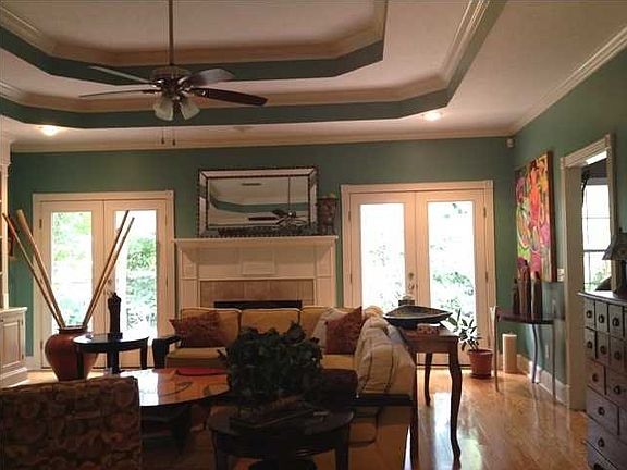 Elegant formal dining with wood flooring greets family and friends as it is located just off the formal entry foyer.