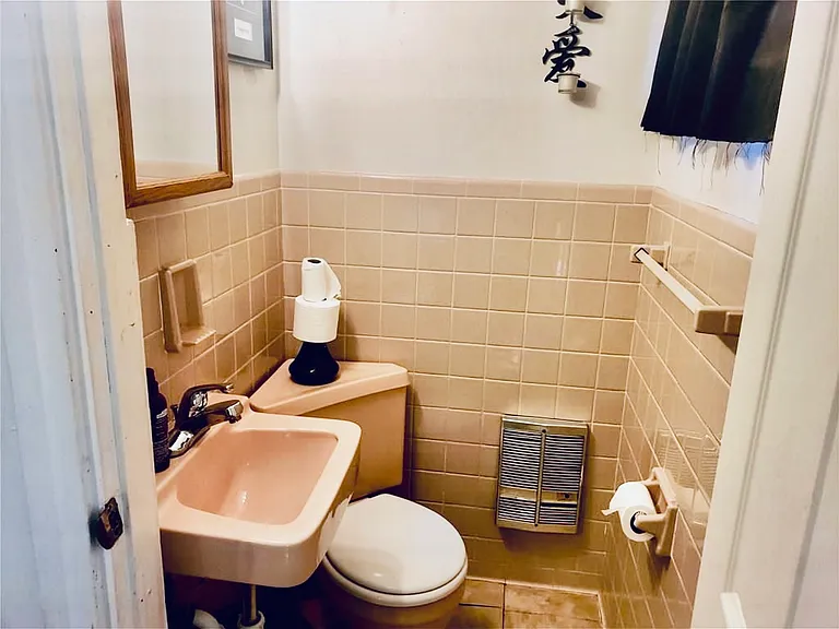 Conveniently located half bathroom off the living room area, offering easy access for guests and everyday use. Clean and well-maintained, it adds extra functionality to the main living space without disrupting the home's open and comfortable flow.