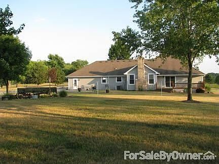 Back of Home : Deck and patio.Deck can be accessed thru LR or MBR.