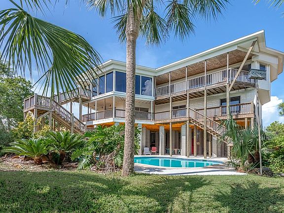 FROM THE BACKYARD, 146 SANDY CV OFFERS A STRKING REAR ELEVATION WITH BALCONIES SPANNING EACH LEVEL. THE HIGH ELEVATION ALSO CREATES GREAT OUTDOOR LIVING AREAS AND STORAGE UNDER THE HOUSE AS WELL. THE RARE, LARGE LOT ALSO OFFERS A POOL, TENNIS COURT A