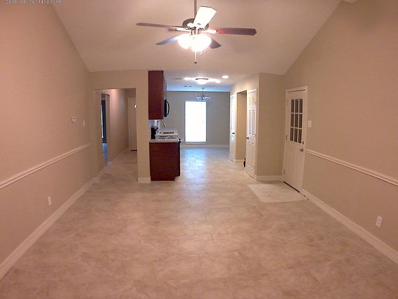 Open floor plan, vaulted ceiling W/fan and LOTS of light!