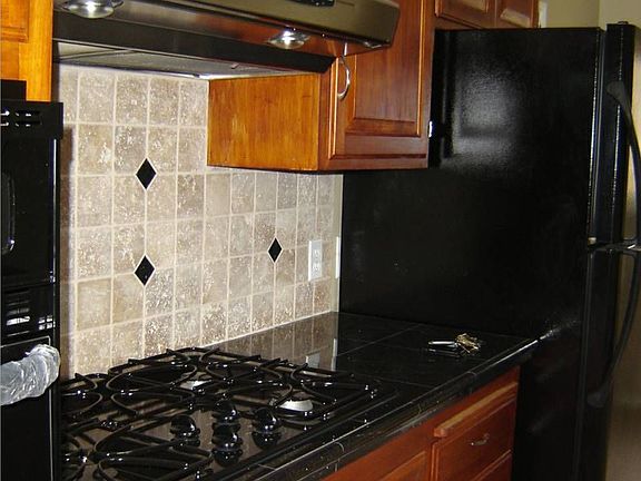 Remodeled kitchen, tumbled marble backsplash, granite countertops