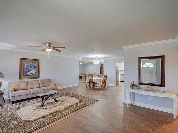 Look at the finishes!  Beautiful Tile Plank FLooring.  Crown Molding.  New Ceiling Fans.  And so very very open.