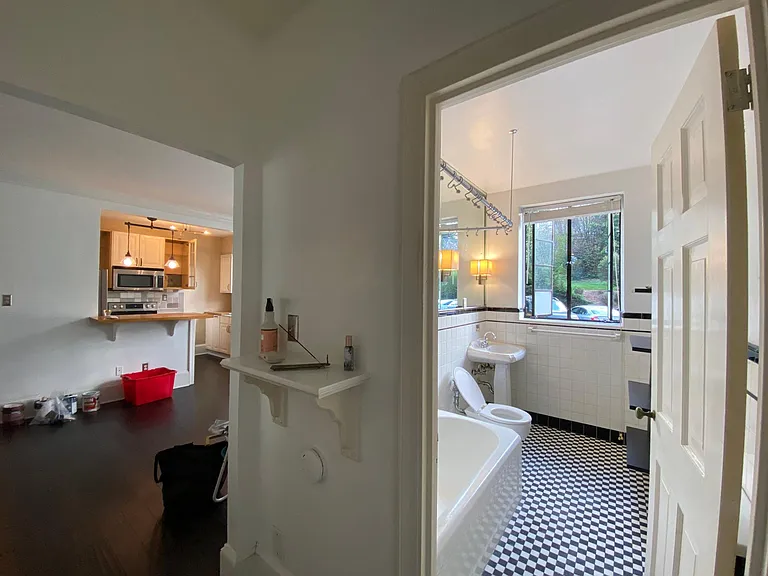 living room flows into hallway to bathroom and bedroom