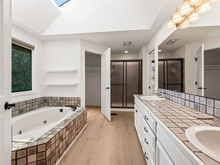 Master bathroom with tub and shower