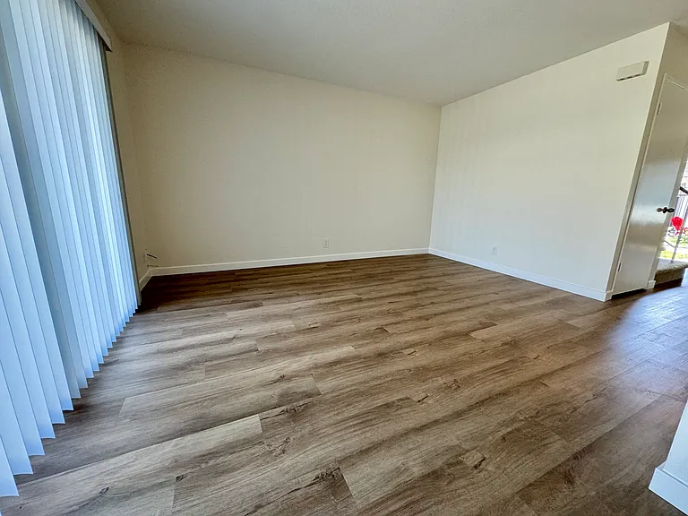 Dining/family room with new vinyl plank flooring, new paint & blinds!