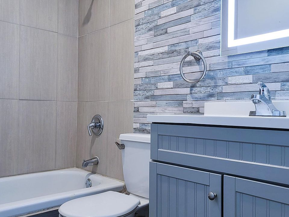 Bathroom with lighted mirror and modern fittings.