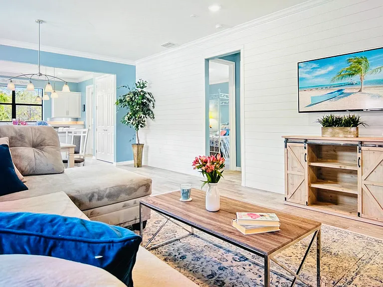 Bright open concept living, dining and kitchen with Shiplap accent wall