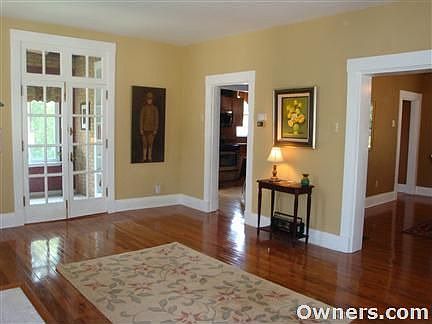 Living Room offers new hardwood and french doors to den/sunroom