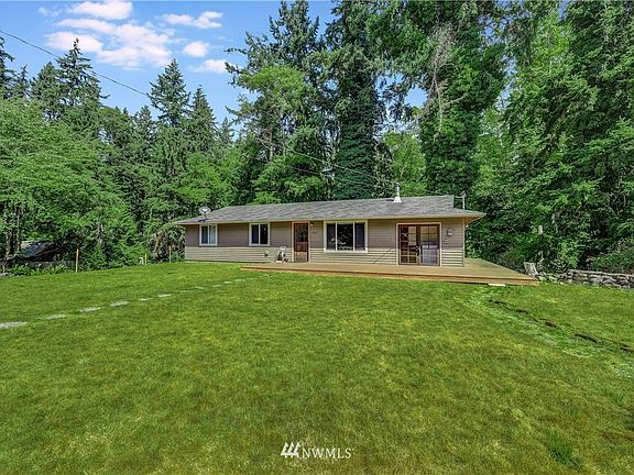 This lovely home is nestled among mature trees for ultimate privacy. 