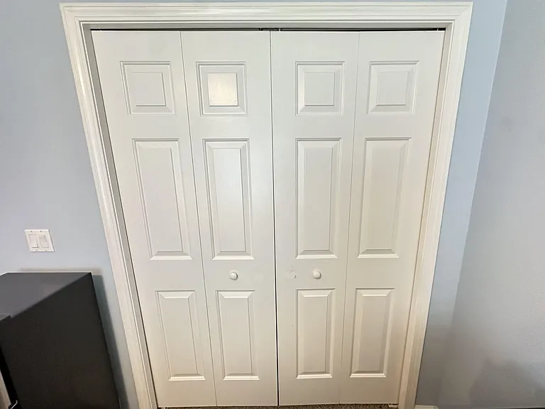 Bedroom closet with double bi-fold doors offers convenient in-room storage for clothing and personal items.