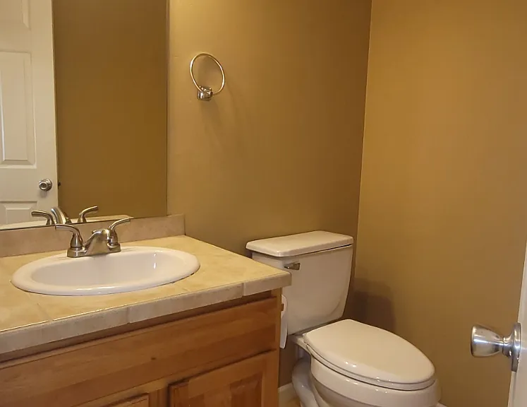 Half bath next to the kitchen and coat closet