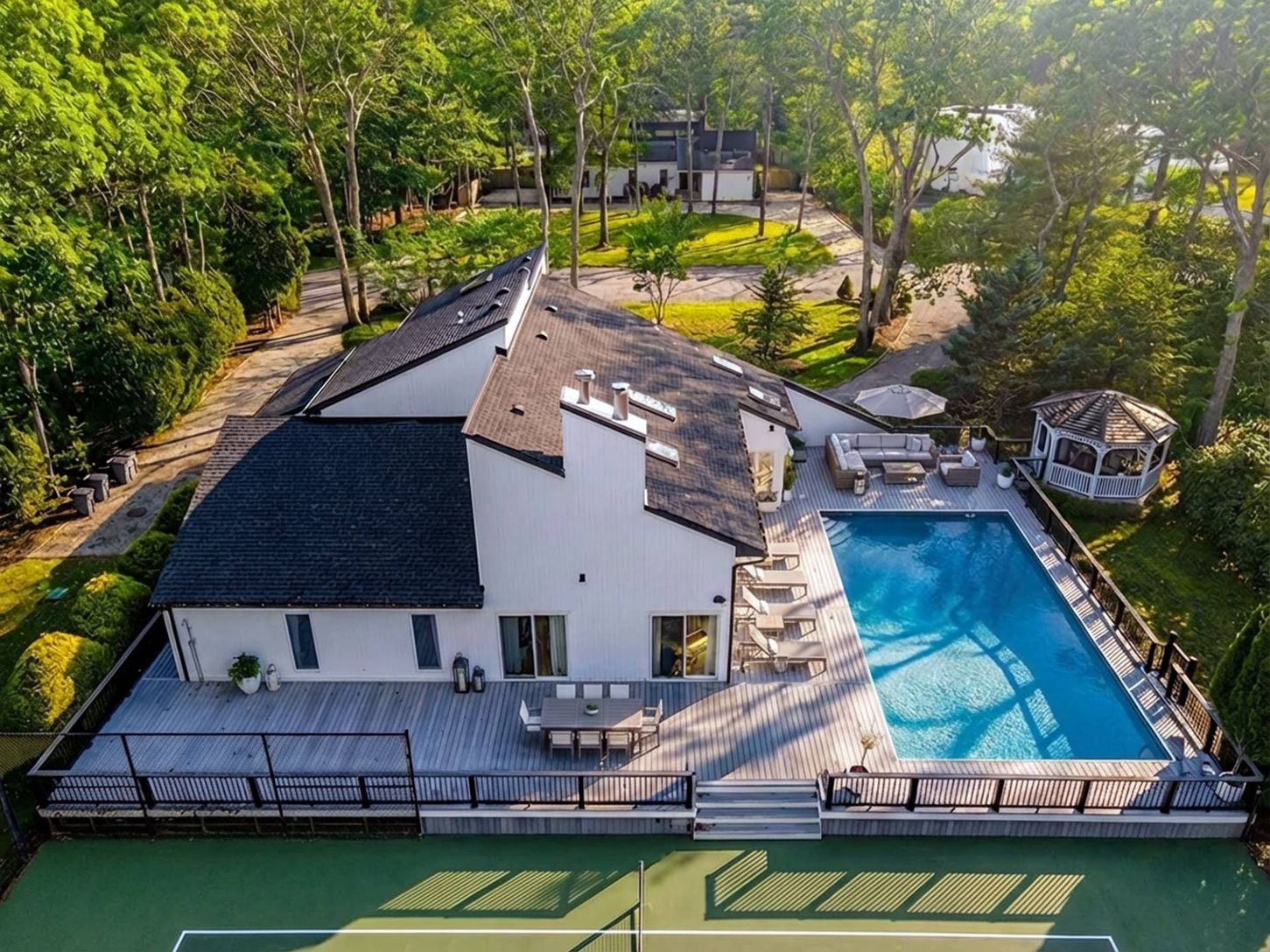 Aerial View closeup of the spacious wraparound Deck with Pool and Tennis