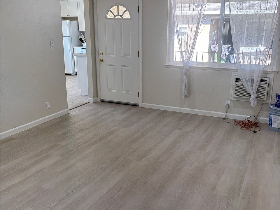 Lovely living room with see thru valances-curtains and air conditioning.