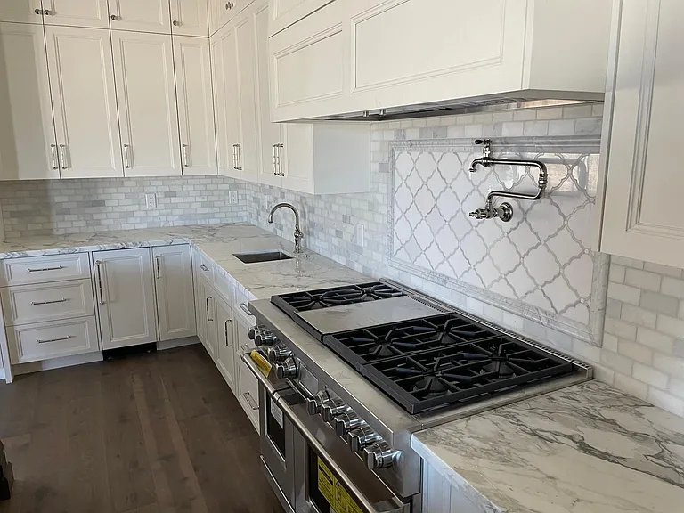 Stove/oven, pot filler, custom marble counters and marble backslash, extra sink, ice maker