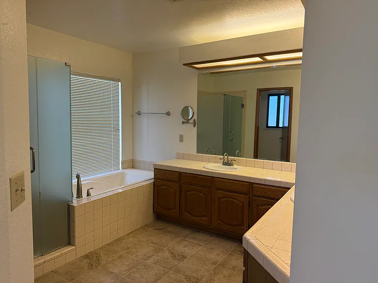 Master bath with soaking tub and separate shower. Dual sinks and separate toilet area.