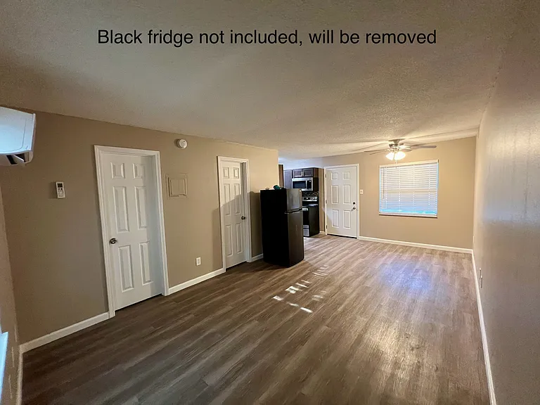 shows studio and both doors to closet and bathroom and entry door and front window