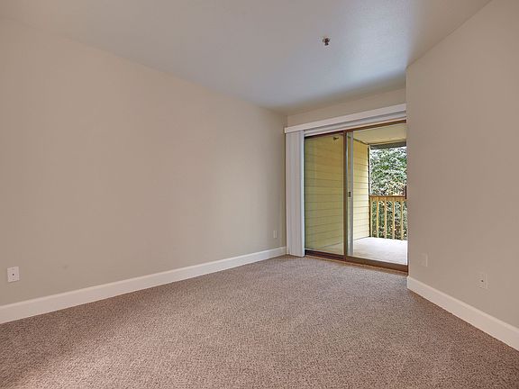 Large living area with sliding glass doors out to the balcony