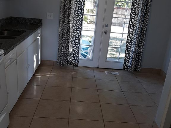 Kitchen with french door leading to back yard. We provide all the drapes (unless you wish to get your own.)