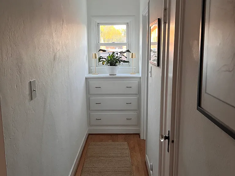 Built in storage cabinet at the end of the hall