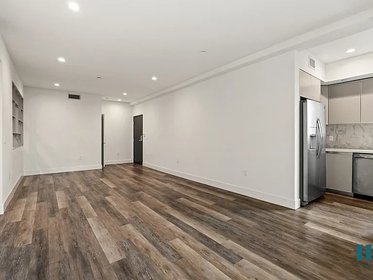 Open-Concept Dining and Living Room with Vinyl Flooring and Recessed Lighting