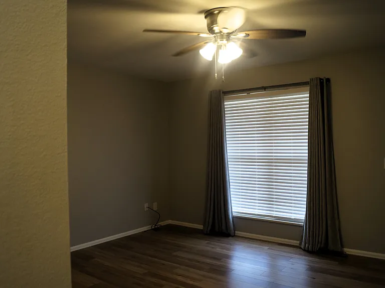 15.5' X 12.5' Livingroom. Thermal blackout curtains, faux wood blinds.