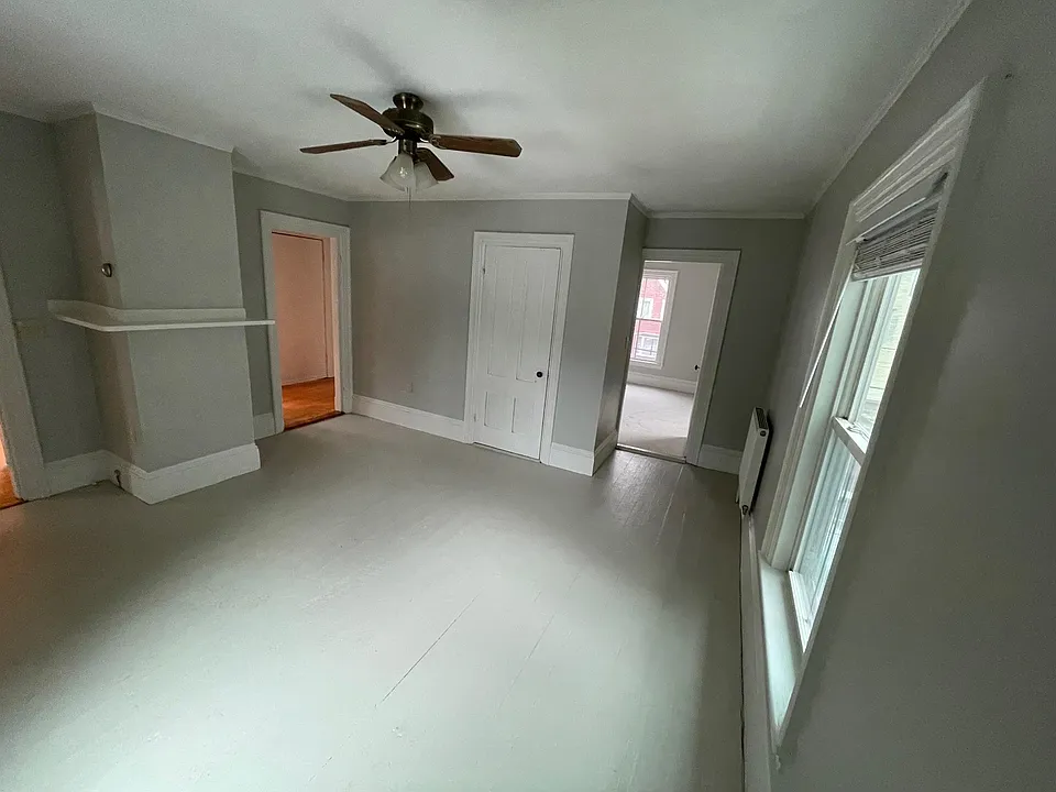 Another view of the living room. on the left can see doorway to the entranceway hall, closet and doorway to front bedroom.