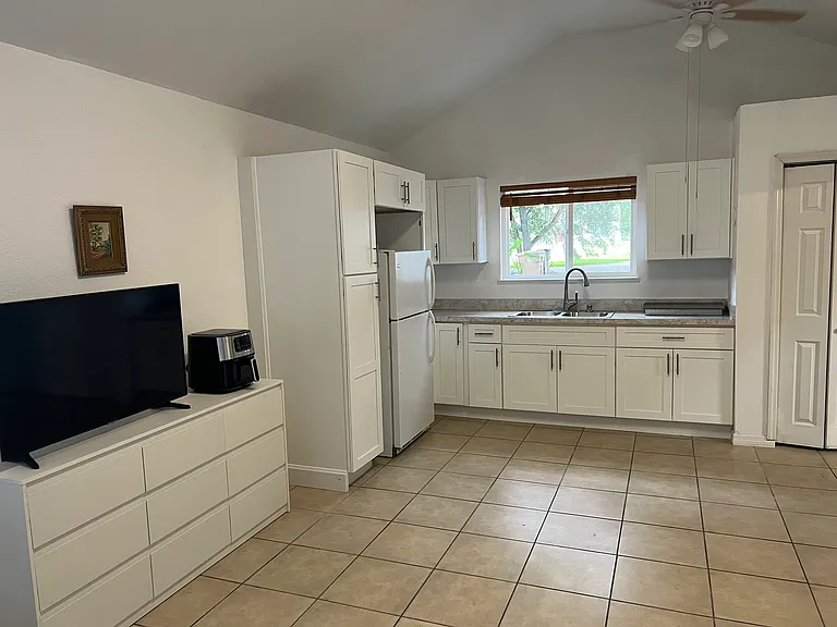 Another spacious kitchen view that shows the dresser, which can double for clothing or kitchen items.