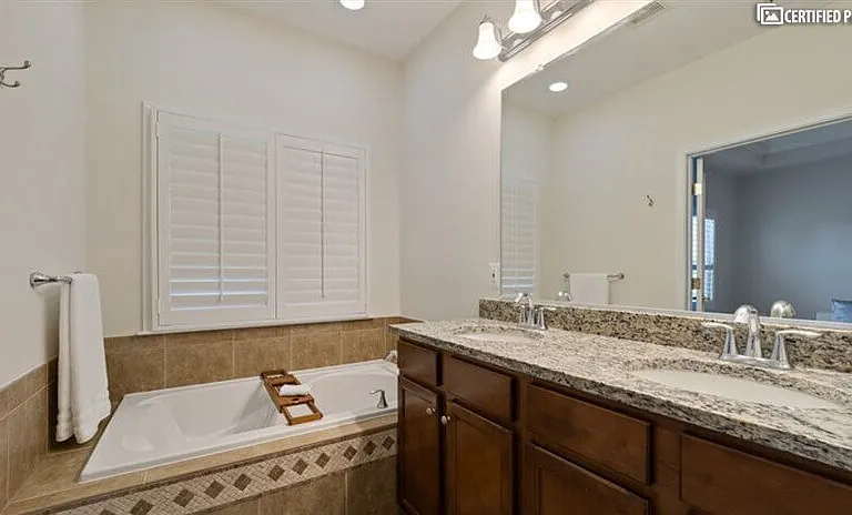 Master bath with dual sinks and soaking tub.