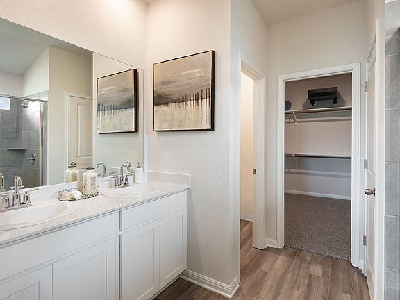 Find his-and-hers sinks, a walk-in shower, and spacious walk-in closet in the primary bath.