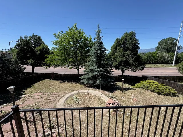 Large terraced backyard with mature trees.