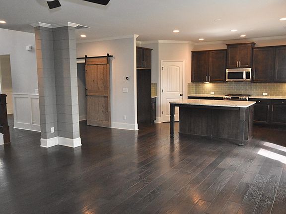 Open floor plan with large laundry on main; walk-in pantry; oversized island w/seating for 3; breakfast area; under cabinet lighting. FRIDGE WILL BE INCLUDED INCLUDED WITH APPLIANCES!