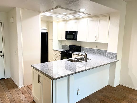 Kitchen with all black appliances and upgraded LED lighting