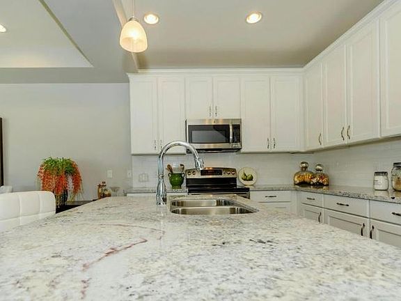 Beautiful granite counter tops with white kitchen cabinets