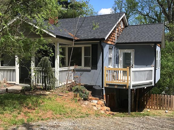 There are two driveways and street parking. There is a gravel driveway on either side of the house