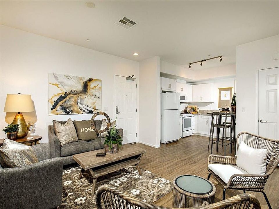 Open concept kitchen with the white refrigerator atove microwave cabinets