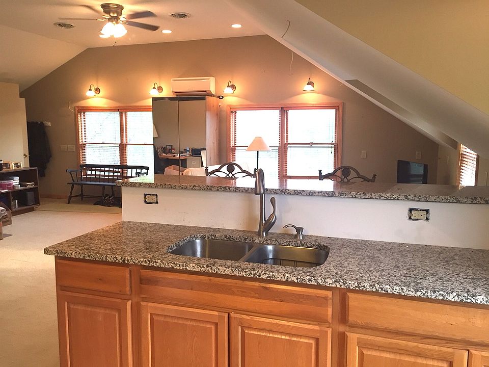 North windows on far wall, view from kitchen. Tall ceilings, open space.