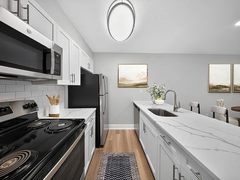 Step into the modern kitchen at The Woods at Ambler, an Eagle Rock Community, where contemporary design meets functionality. With sleek appliances and ample counter space, it's perfect for culinary enthusiasts. Schedule your tour today!
