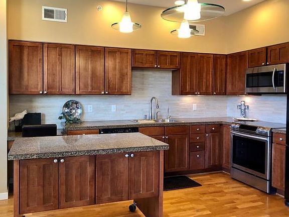 Kitchen with mobile island adjacent to dining area