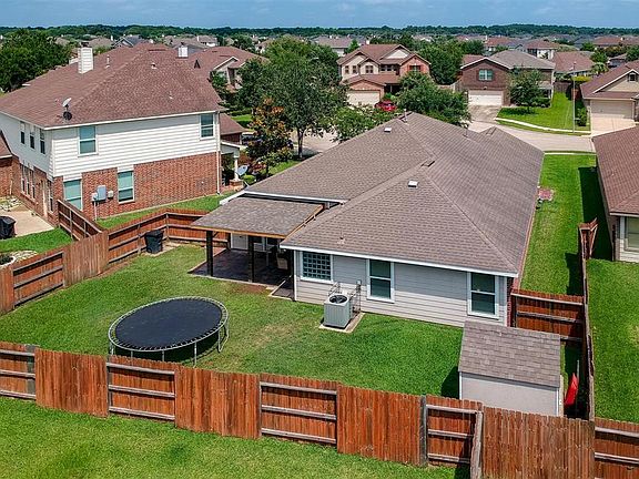 Spacious back yard with covered patio and shed.