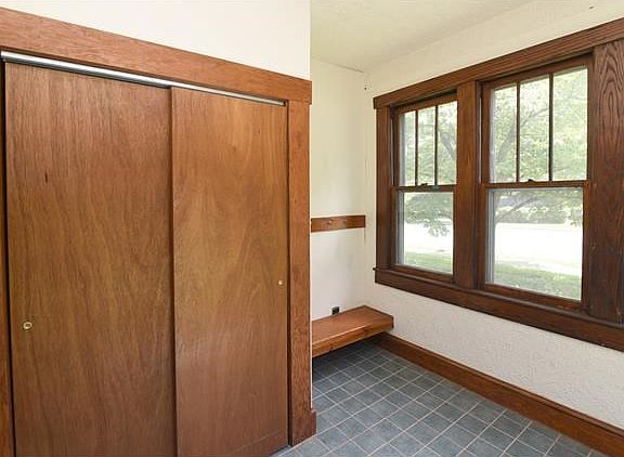 Entry porch with closet in front of house.