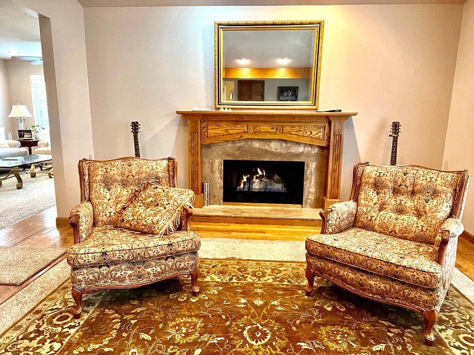 Formal living room with fireplace and vaulted beamed ceilings