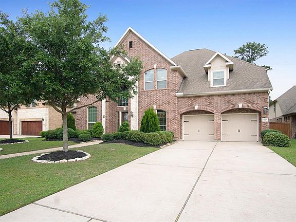 Beautiful brick and stone elevation with a 3-car tandem garage and double wide driveway.