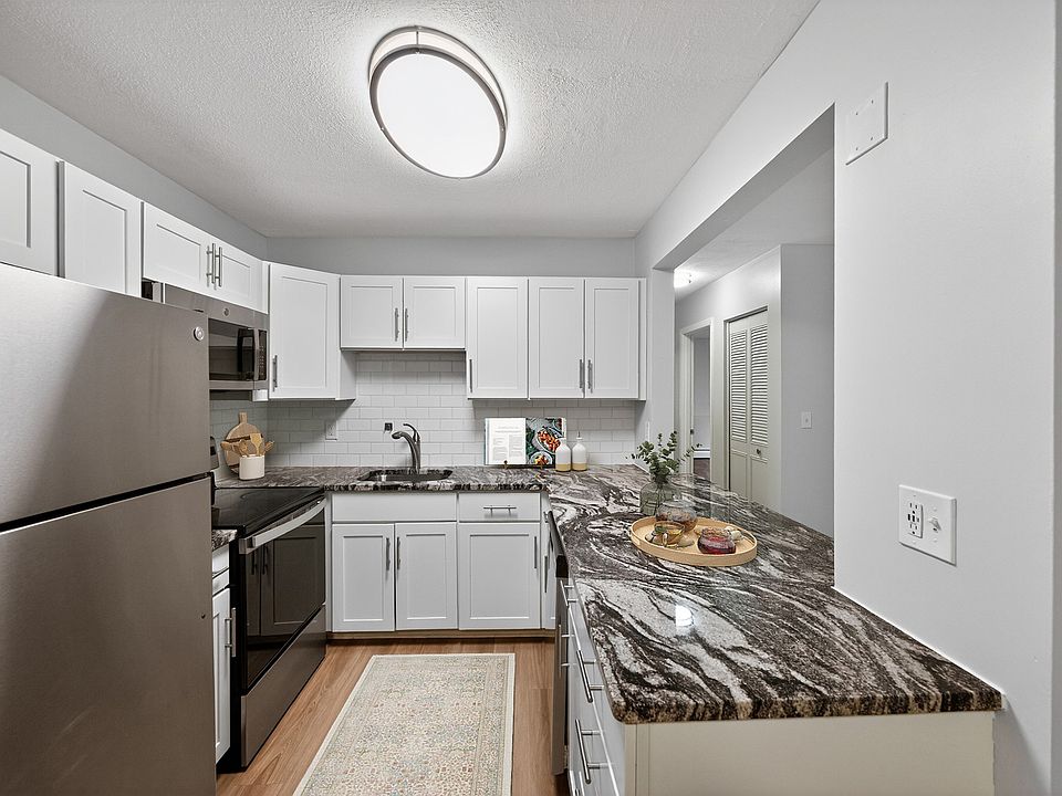 Elevate your lifestyle at Park Village West with this modern kitchen featuring sleek stainless steel appliances and elegant granite countertops. Designed for both style and functionality, it's perfect for culinary creativity. Schedule a tour today!