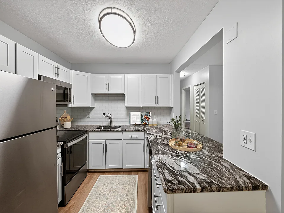 Elevate your lifestyle at Park Village West with this modern kitchen featuring sleek stainless steel appliances and elegant granite countertops. Designed for both style and functionality, it's perfect for culinary creativity. Schedule a tour today!